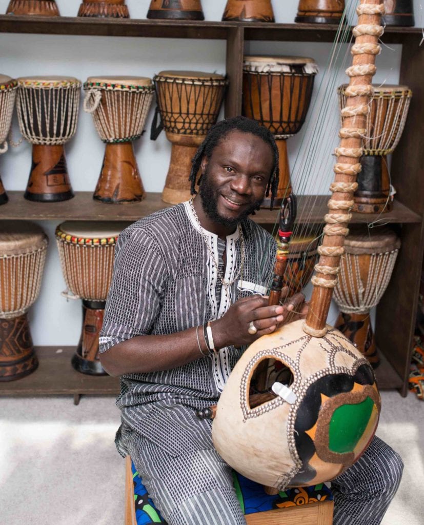 Diali Cisshiko with his collection of traditional drums and the kora.