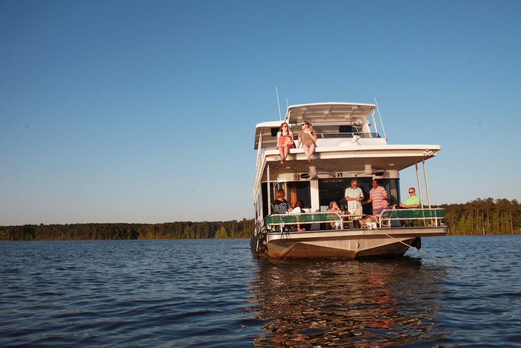 Paula and Greg Stafford with guests aboard their houseboat on Jordan Lake.