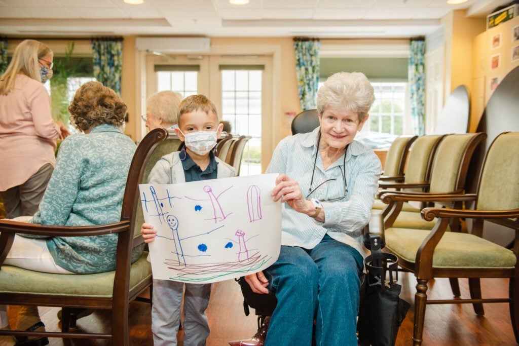 Boy holds his artwork with Galloway Ridge resident